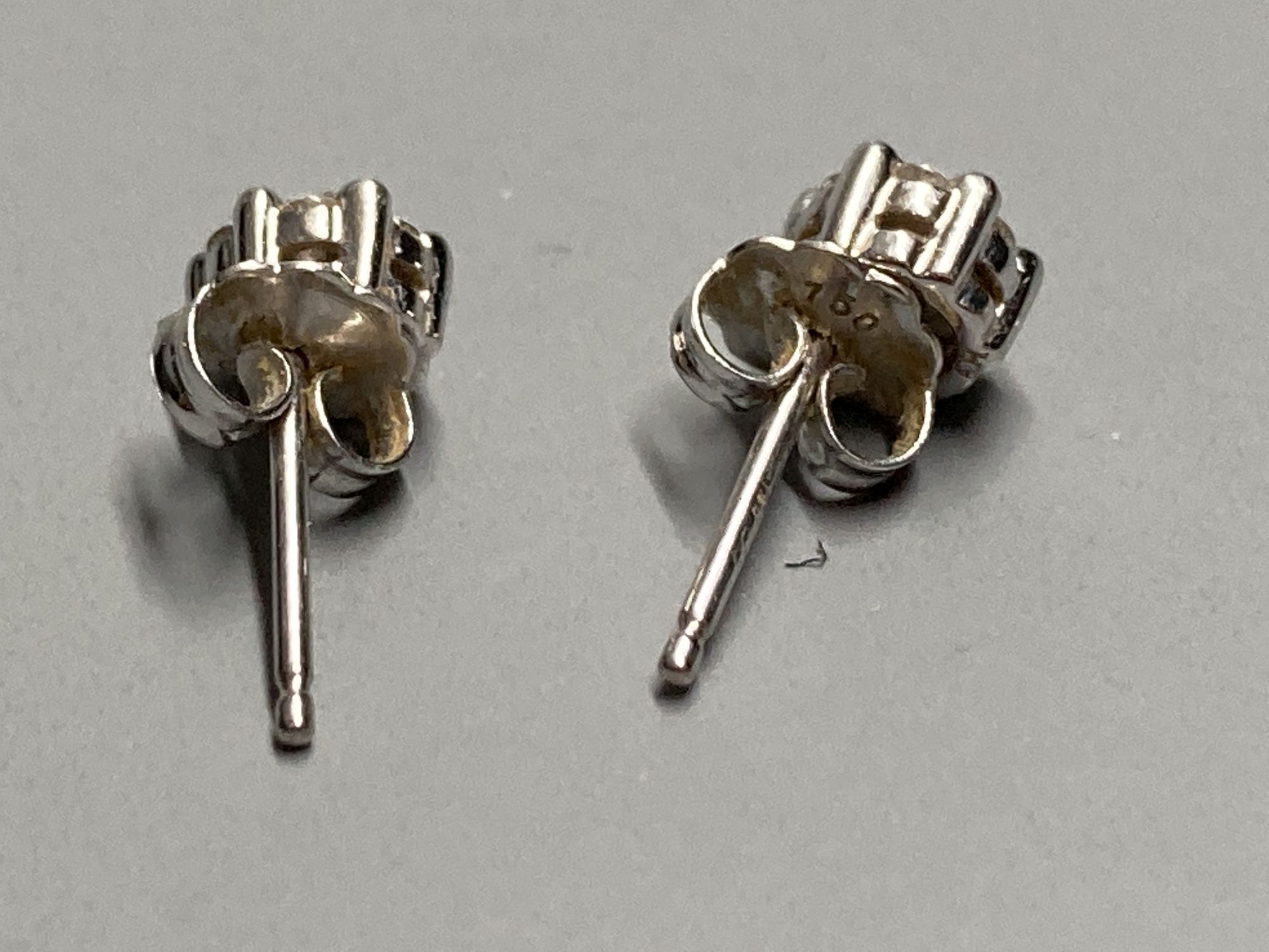 A pair of modern white metal (stamped 750) and small seven stone diamond cluster ear studs, 5mm, gross 1.6 grams.